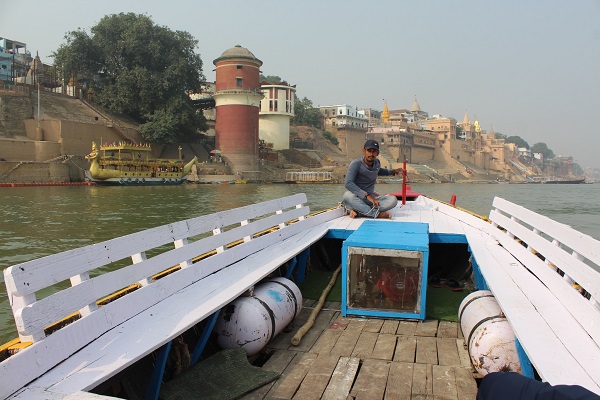 Open wooden boat seating on the Ganga