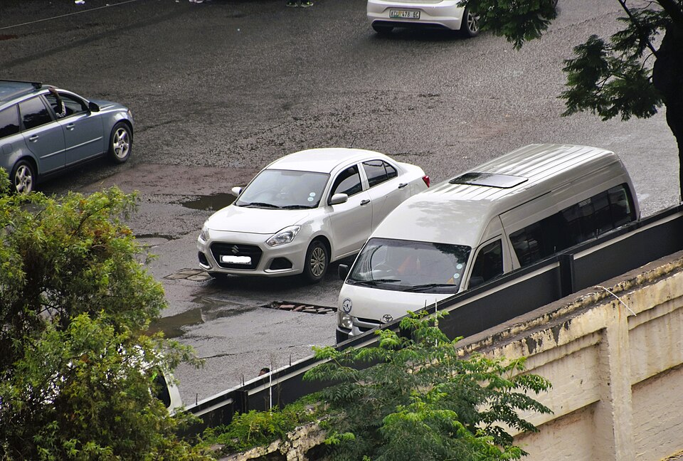 White Suzuki Swift Dzire sedan shown as a cab example